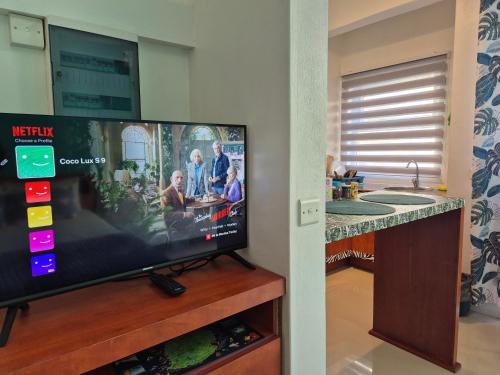 a flat screen tv sitting on top of a wooden stand at Coco Lux Mon Amour in Grand Baie