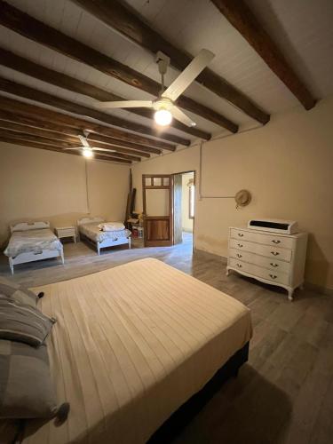 a large bedroom with two beds and a dresser at Casa ullum in San Juan