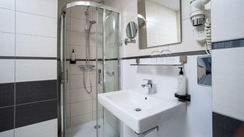 a bathroom with a sink and a shower at B&B HOTEL Piotrków Trybunalski in Piotrków Trybunalski