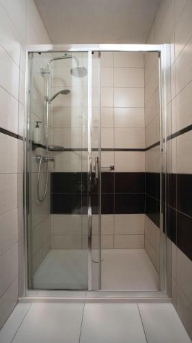 a shower with a glass door in a bathroom at B&B HOTEL Piotrków Trybunalski in Piotrków Trybunalski