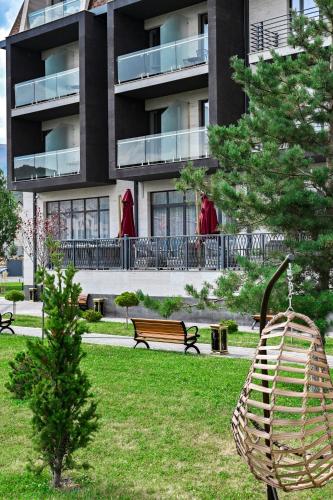 a park with a swing in front of a building at SIA Resort and SPA in Tsaghkadzor