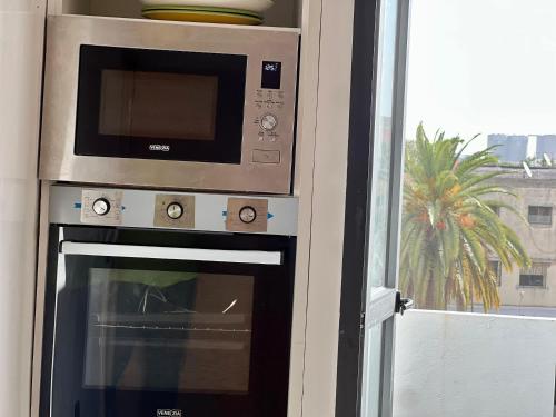 a microwave oven sitting next to a window at Luxury Apartment Casablanca - Ain Sebaa, Zoo View in Casablanca