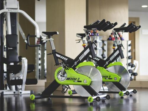 two green bikes parked in a gym at Novotel Bogota Parque 93 in Bogotá