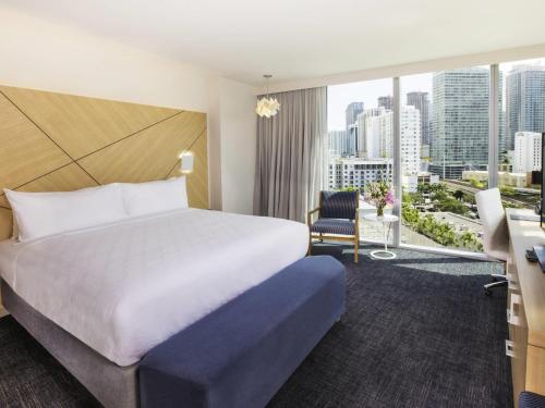 a hotel room with a bed and a large window at Novotel Miami Brickell in Miami