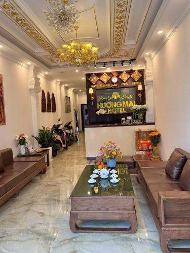 a lobby of a hotel with couches and a table at Huong Mai Hotel in Da Lat
