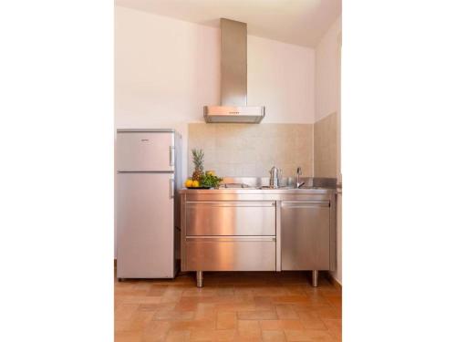 a kitchen with a refrigerator and a sink at Gitavillage Club degli Amici in Pescia Romana