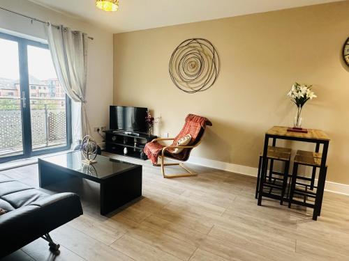 a living room with a couch and a chair at Grand Central Apartments, Centro in Derby