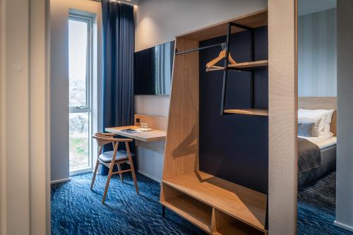 a room with a bed and a desk in a room at HOTEL SØMA Sisimiut in Sisimiut