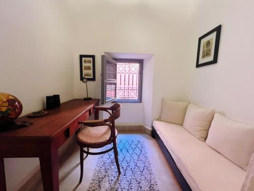 a living room with a desk and a couch at Riad Tchaikana in Marrakech