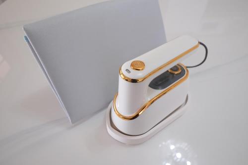 a white and gold cell phone sitting next to a laptop at TDR車9分 3BR 5Bed 夢の続きを楽しめる宿 -TAMU-LAND Kasai- in Tokyo