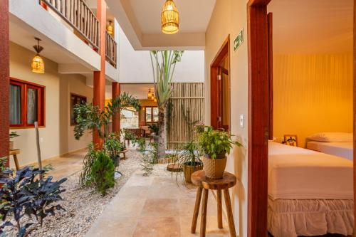 a bedroom with potted plants and a bed at Vila Dádiva Jeri in Jericoacoara