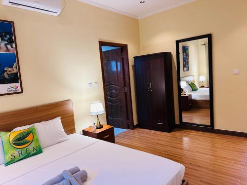 a hotel room with a bed and a mirror at Sren Self Catering - One Bedroom II in Anse Royale