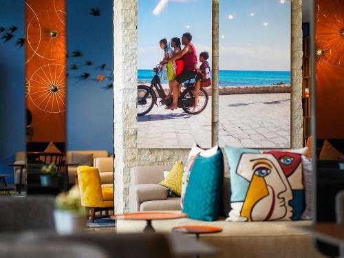 a group of people riding a bike on the beach at Aparthotel Adagio Premium Casablanca City Center in Casablanca