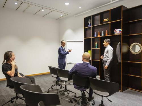 a group of people in a room with a presentation at Aparthotel Adagio Premium Casablanca City Center in Casablanca