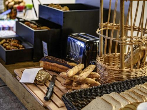 a display of bread and pastries on a table at ibis budget Saint-Étienne Centre Gare Châteaucreux in Saint-Étienne