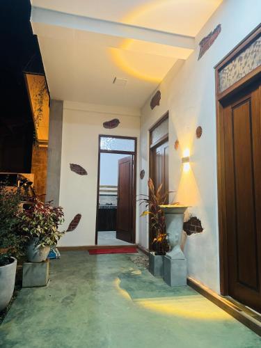 a hallway of a house with a door and plants at The La Nature Villa in Wadduwa