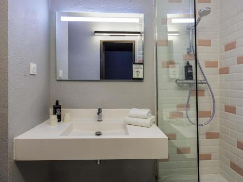 a bathroom with a sink and a shower at Ibis Styles Toulouse Centre Canal du Midi in Toulouse
