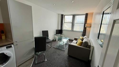 a living room with a couch and a table at The Victoria Family Apartment 202 in Halifax