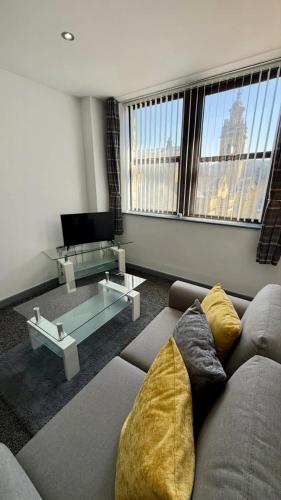 a living room with a couch and a large window at The Victoria Family Apartment 202 in Halifax