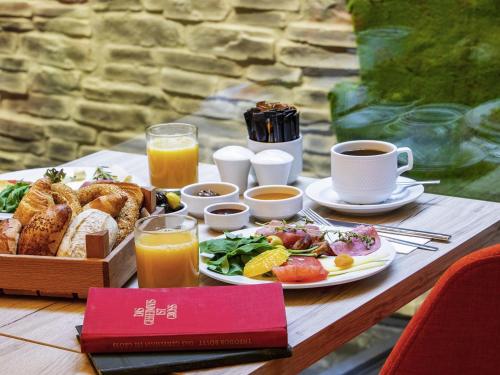 a table with a tray of breakfast foods and coffee at Ibis Styles Istanbul Atasehir in Istanbul
