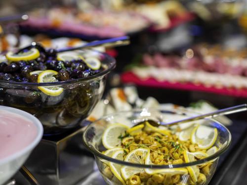 a table with two bowls of food with olives and lemons at Ibis Styles Istanbul Atasehir in Istanbul