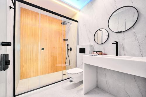a bathroom with a shower and a toilet and a sink at AKTEON GIRNI in Paralia Katerinis
