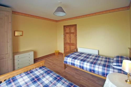 a bedroom with two beds and a dresser at 4 Bed in Clifden oc-i243 in Belleek