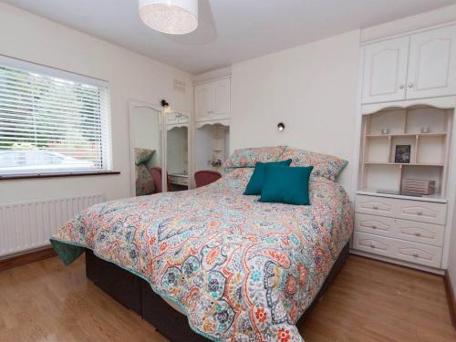 a bedroom with a large bed with green pillows at 4 Bed in Clonbur oc-ii16388 in Clonbur