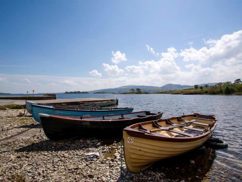 three boats sitting on the shore of a lake at 4 Bed in Clonbur oc-ii16388 in Clonbur