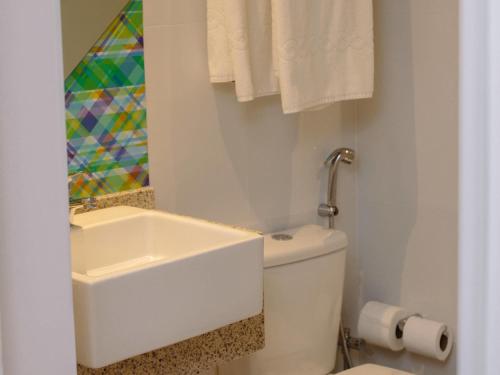a white bathroom with a sink and a toilet at ibis Styles Campina Grande in Campina Grande