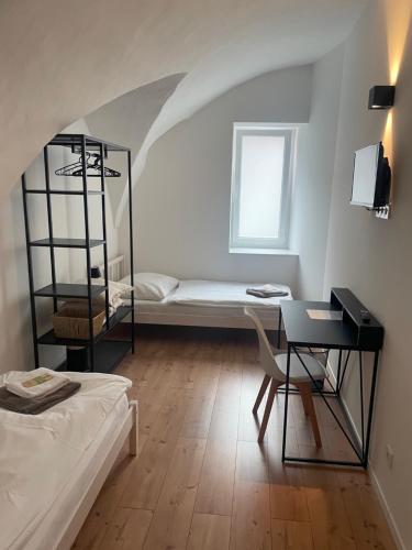 a room with a bed and a desk and a window at room4you Lambach in Lambach