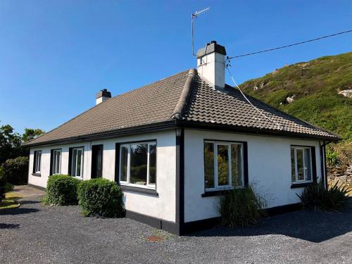a white house with a chimney on top of it at 5 Bed in Clifden oc-ii05854 in Kill