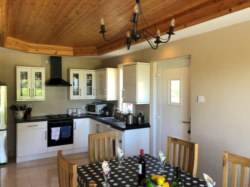 a kitchen with a table and a dining room at 5 Bed in Clifden oc-ii05854 in Kill