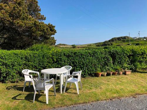 a white table and four chairs sitting around a table at 5 Bed in Clifden oc-ii05854 in Kill