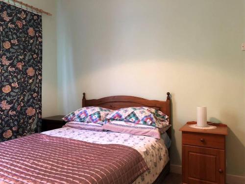 a bedroom with a bed and a candle on a dresser at 5 Bed in Clifden oc-ii05854 in Kill
