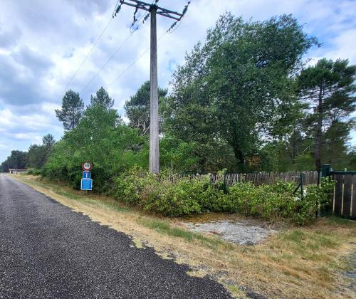 a telephone pole on the side of a road at La Tiny Des Bruyères 