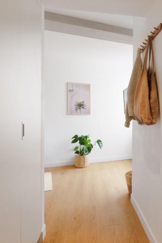 a living room with white walls and a wooden floor at Babel Community Hôtel - Montpellier centre in Montpellier