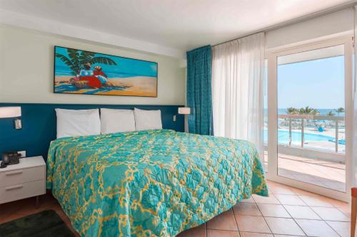 a bedroom with a bed and a view of a pool at Royal Islander Club Resort La Terrasse in Lowlands