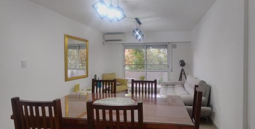 a living room with a table and a couch at Apartamento espacioso en Rosario in Rosario