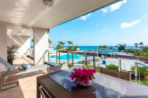 a balcony with a view of the beach and the ocean at Royal Islander Club Resort La Terrasse in Lowlands