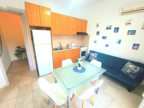a kitchen with a blue table and white chairs at Faros studios Kalymnos Lighthouse in Kalymnos