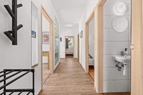 a hallway leading to a bathroom with a sink at DV Apartment in Pješčana Uvala 