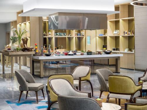 a lobby with a large table and chairs at InterContinental Hotels Jakarta Pondok Indah by IHG in Jakarta