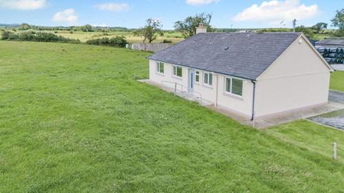 an aerial view of a small white building in a field at 3 Bed in Kerry oc-g32088 in Shrone