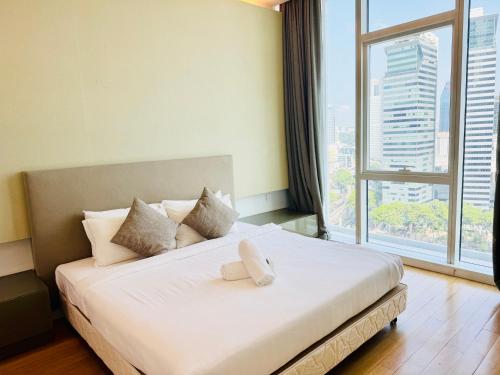 a bedroom with a large bed with a large window at Platinum Suites Klcc By Divina in Kuala Lumpur