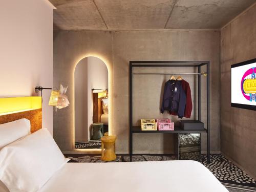 a bedroom with a bed and a mirror at Mama Shelter Lille in Lille