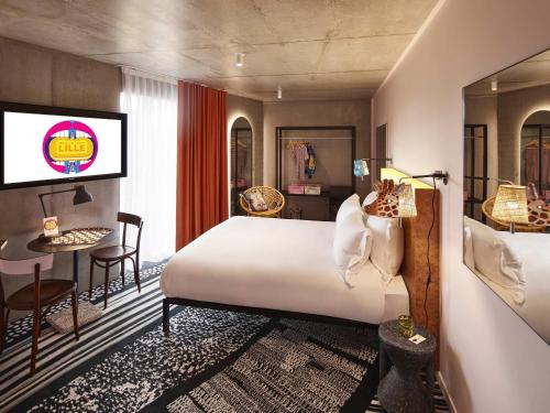 a hotel room with a bed and a tv at Mama Shelter Lille in Lille