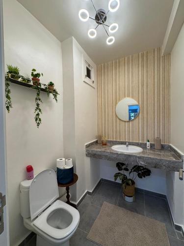 a bathroom with a toilet and a sink at Lunja vibe in Agadir nʼ Aït Sa