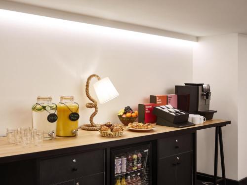 a counter with drinks and snacks on it at Mama Shelter London - Shoreditch in London