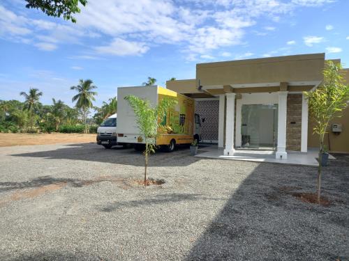 a yellow truck parked in front of a building at Onera Hotel & restaurant in Mahiyangana